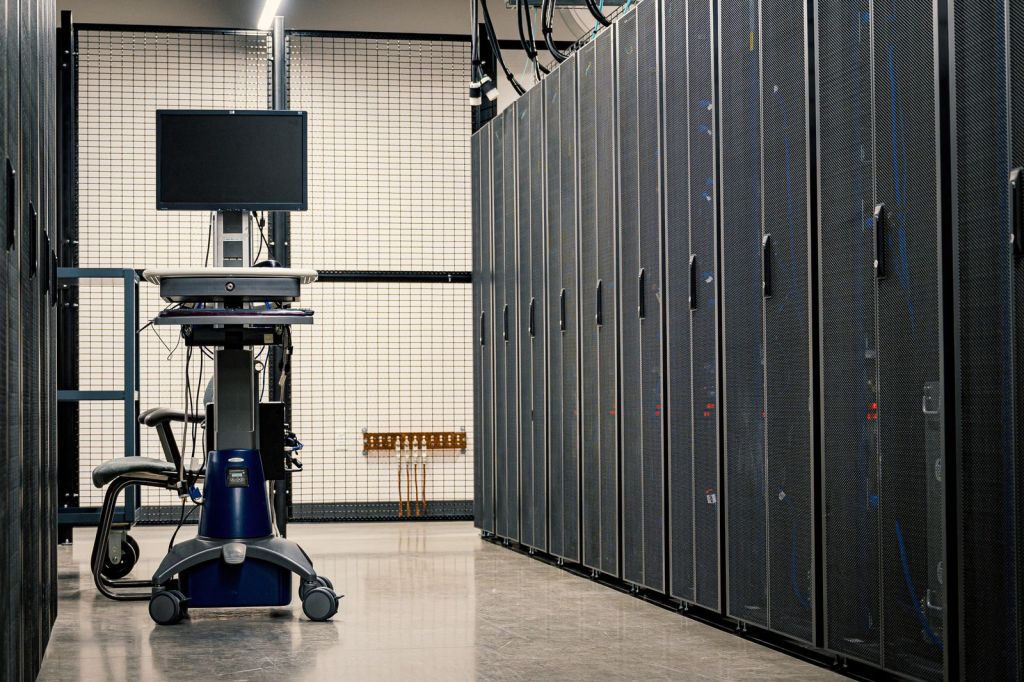 Interior of a data centre with rows of server racks and operating equipment