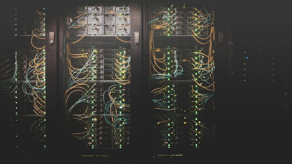 Network cables connected to servers in a data centre rack
