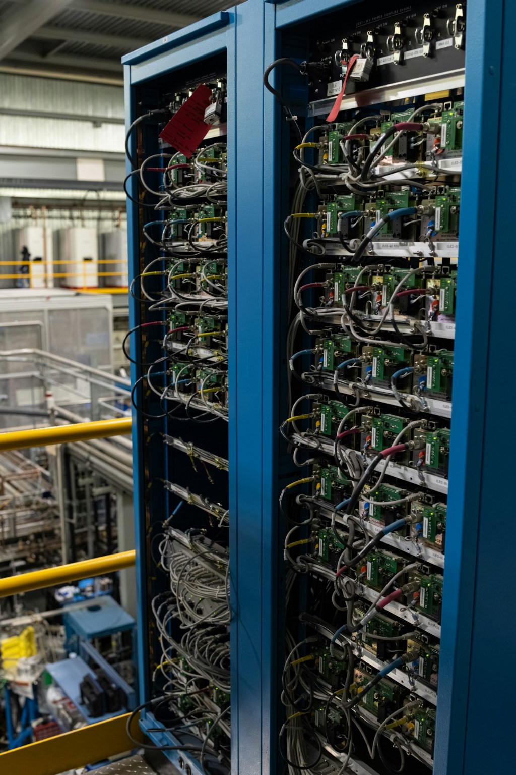Two server racks filled with electronic components and cabling