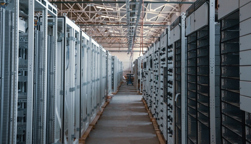 Aisle between metal equipment racks in a server room