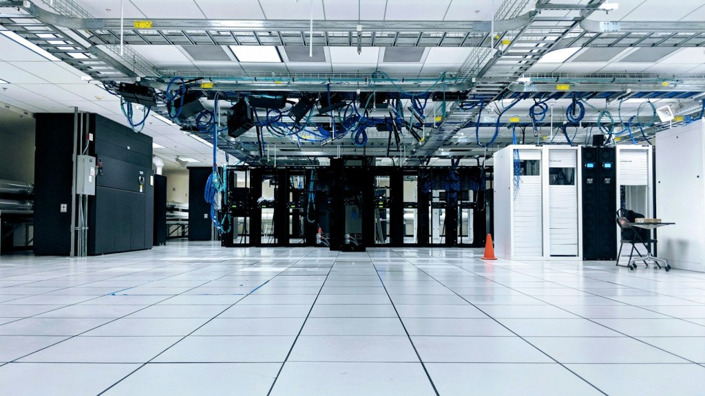 Server room with rows of black and white network cabinets